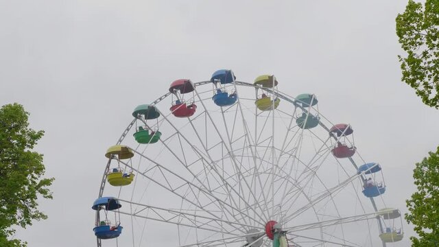 Underside view of a ferris wheel over blue sky. UltraHD stock footage.
