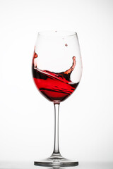 Red wine splashes in a glass