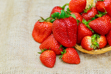strawberries in a basket on wooden table strawberries on a brown background