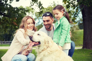 happy family with labrador retriever dog in park