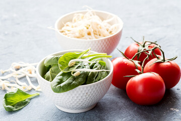 Raw spinach and sprouts Raw red tomatoes Copy space Horizontal photo