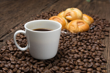 Coffee cup with bread sausage and coffee beans