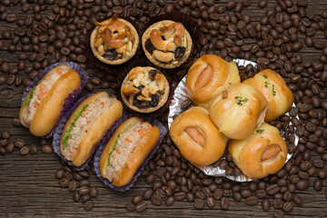 Bakery with coffee beans on dark wooden background