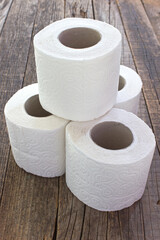 Toilet paper rolls on wood background