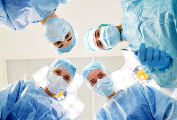 group of surgeons in operating room at hospital