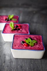 Berry smoothie on black wooden background - Well being, Healthy eating, Detox or Diet concept. Selective focus