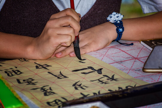Calligrapher &ndash; Chinese girl doing calligraphy exercise