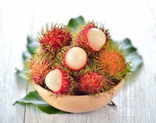 Fresh rambutans in wood bowl