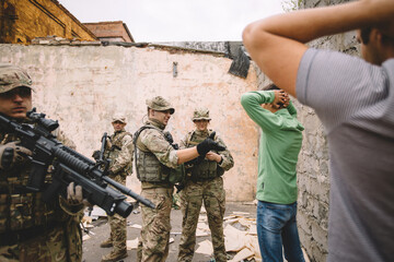 Fototapeta premium soldiers with weapon captured peoples