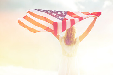happy young woman with american flag outdoors