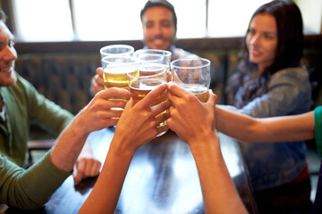 happy friends drinking beer at bar or pub