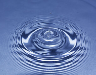 Blue water drop falling down. Blue water splash.
