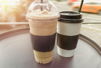 frappe and coffee mug on black round table