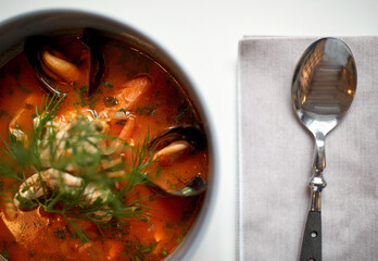 close up of seafood soup with fish and mussels