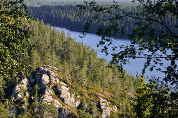 View from hill on rock face, forest and river. Finland - 157426927