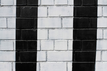 Naklejka premium Black and white painted brick wall as background, texture