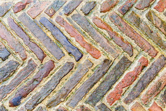 Old bricks in pattern on a street