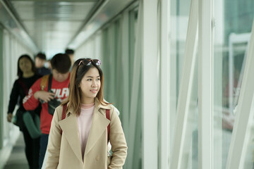 Charming beautiful asian business woman smile and walking in jet bridge. Go to work and travel.