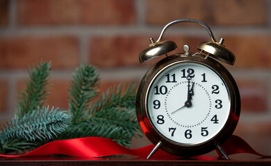 alarm clock, fir branch and ribbon