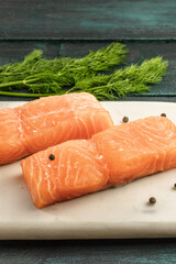 Two slices of salmon on dark background with copyspace