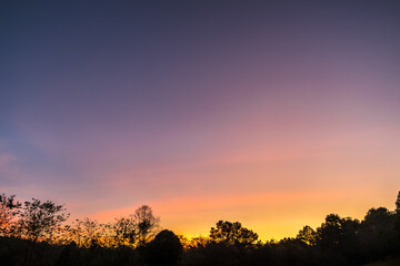 Twilight sky with silhouette trees in the evening after sunset