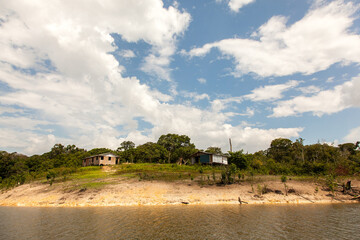 Obraz na płótnie Canvas Simple houses on Amazon river island