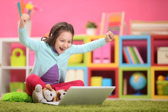 Cute little girl with  laptop 