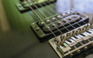 Fototapeta na wymiar Electric guitar part close-up. Neck and humbucker pickup. Horizontal composition. Studio shot.