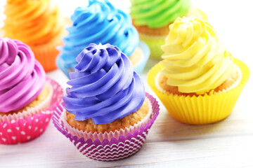Tasty cupcakes on a white wooden table