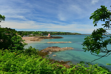 Archirondel, Jersey, U.K.  Wide angle Summer image of an idyllic coastline with a teal sea.