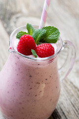Raspberry milk shake with mint decor.