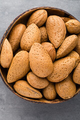 Group of almond nuts with leaves.Wooden background.