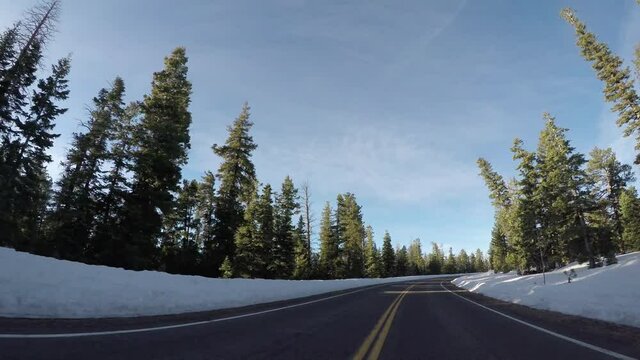 Road Through Snowy Bryce Canyon on Sunny Day in Early Spring
