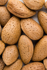 Group of almond nuts with leaves.Wooden background.