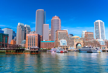 Fototapeta na wymiar Boston cityscape reflected in water, skyscrapers and office buildings in downtown, view from Boston harbor, Massachusetts, USA