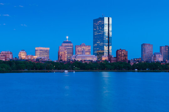 Evening cityscape of Boston, buildings in Back Bay district reflected in water, USA