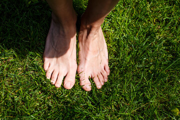 Female legs on green grass