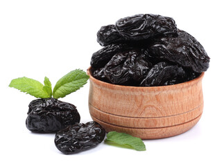 Dried plums - prunes in wooden bowl isolated on white background