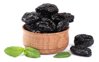 Dried plums - prunes in wooden bowl isolated on white background