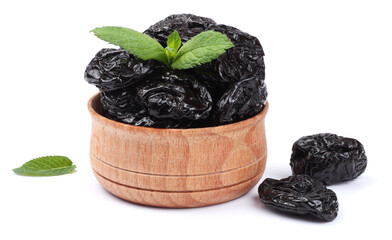 Dried plums - prunes in wooden bowl isolated on white background