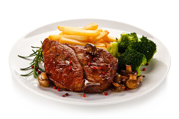 Grilled beefsteak with french fries and broccoli on white background