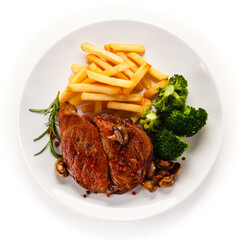 Grilled beefsteak with french fries and broccoli on white background