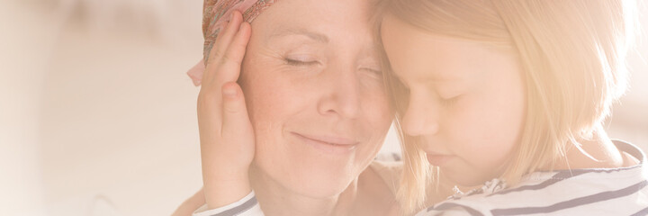 Girl embracing mother's face