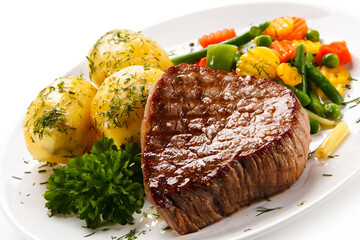 Grilled beefsteak with potatoes on white background
