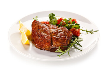 Grilled beefsteak with vegetables on white background