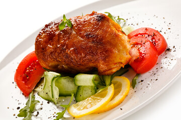 Grilled chicken fillet with vegetables on white background