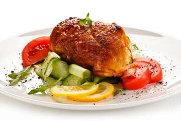 Grilled chicken fillet with vegetables on white background