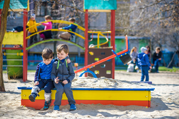 brothers are playing together on the playground