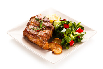 Grilled beefsteak with vegetables on white background