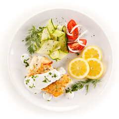 Fried cod and vegetables on white background